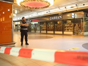 A Dutch military police officer is stationed in departure Hall 3 of Schiphol airport on Monday, Dec. 31, 2018, after it was temporarily closed following threats by an unkown man that he was carrying a bomb.