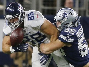 In this Monday, Nov. 5, 2018 file photo, Tennessee Titans tight end Luke Stocker (88) bobbles the ball as Dallas Cowboys linebacker Leighton Vander Esch (55) defends during the first half of an NFL football game in Arlington, Texas.