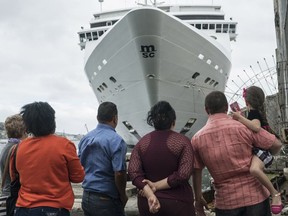 People stand in front of an MSC Cruises ship docked in Havana, Cuba, on Jan. 27, 2018. (Bloomberg photo by Francesco Pistilli)