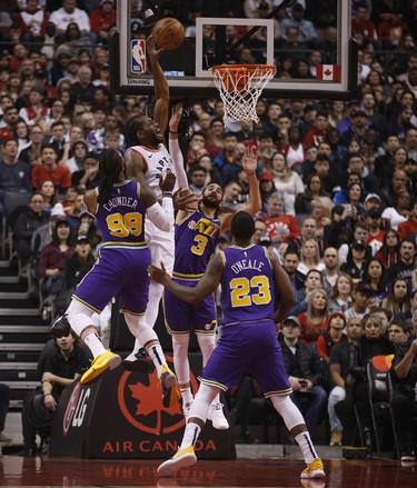 Toronto Raptors Kawhi Leonard SF (2) goes up to the basket and is fouled by Utah Jazz Jae Crowder PF (99) during the first quarter  in Toronto, Ont. on Tuesday January 1, 2019. Jack Boland/Toronto Sun/Postmedia Network