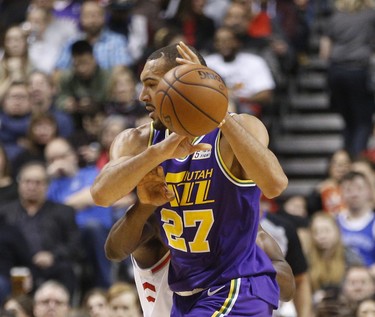 Toronto Raptors Serge Ibaka PF (9) reaches in to knocks the ball from the hands of Utah Jazz Rudy Gobert C (27) during the second half in Toronto, Ont. on Tuesday January 1, 2019. Jack Boland/Toronto Sun/Postmedia Network