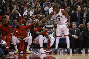 Toronto Raptors Kawhi Leonard SF (2) gets props from his bench during the second half in Toronto, Ont. on Tuesday January 1, 2019. Jack Boland/Toronto Sun/Postmedia Network
