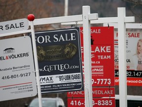 Real estate for sale signs are shown in Oakville, Ont. on Saturday, Dec.1, 2018.