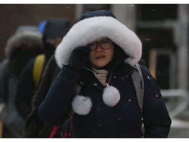 All bundled up at Yonge and Wellesley Sts. as the first major snowfall of the year to hit Toronto. Environment Canada called it "hazardous winter conditions" with snowfall up to 25 centimetres. Temps midday were were -7 C at 4 p.m. but 65 kmh winds made it feel like -18C on Monday January 28, 2019. Jack Boland/Toronto Sun/Postmedia Network