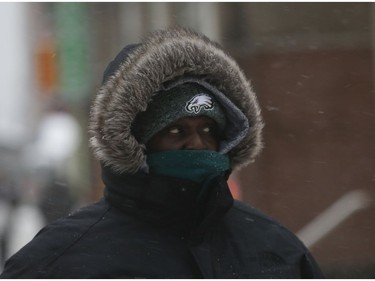 All bundled up at Yonge and Wellesley Sts. as the first major snowfall of the year to hit Toronto. Environment Canada called it "hazardous winter conditions" with snowfall up to 25 centimetres. Temps midday were were -7 C at 4 p.m. but 65 kmh winds made it feel like -18C on Monday January 28, 2019. Jack Boland/Toronto Sun/Postmedia Network