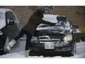 Cleaning off the car at a Green P lot at Yonge and Wellesley Sts.