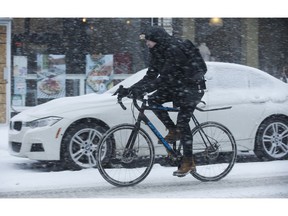 A cyclist heads south on Bathurst from  Dupont Sts. as the first major snowfall of the year to hit Toronto. Environment Canada called it "hazardous winter conditions" with snowfall up to 25 centimetres. Temps midday were were -7 C at 4 p.m. but 65 kmh winds made it feel like -18C on Monday January 28, 2019. Jack Boland/Toronto Sun/Postmedia Network