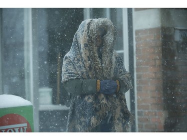 Bundled up at Bathurst and Dupont Sts. as the first major snowfall of the year to hit Toronto. Environment Canada called it "hazardous winter conditions" with snowfall up to 25 centimetres. Temps midday were were -7 C at 4 p.m. but 65 kmh winds made it feel like -18C on Monday January 28, 2019. Jack Boland/Toronto Sun/Postmedia Network