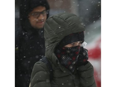 All bundled up at Yonge and Wellesley Sts. as the first major snowfall of the year to hit Toronto. Environment Canada called it "hazardous winter conditions" with snowfall up to 25 centimetres. Temps midday were were -7 C at 4 p.m. but 65 kmh winds made it feel like -18C on Monday January 28, 2019. Jack Boland/Toronto Sun/Postmedia Network