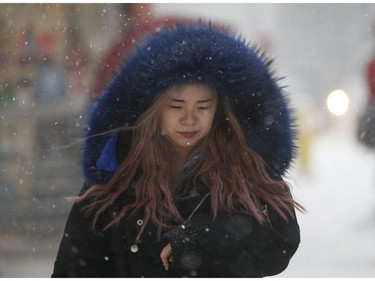 All bundled up at Yonge and Wellesley Sts. as the first major snowfall of the year to hit Toronto. Environment Canada called it "hazardous winter conditions" with snowfall up to 25 centimetres. Temps midday were were -7 C at 4 p.m. but 65 kmh winds made it feel like -18C on Monday January 28, 2019. Jack Boland/Toronto Sun/Postmedia Network