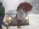 A man uses a huge umbrellas and ski googles to brave the weather at Yonge and Wellesley St. E. in Toronto on Jan. 28, 2019.