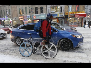 Dennis (pictured) the bike courier said he always wears shorts all year round as he braved the first major snowfall of the year to hit Toronto at Yonge and Wellesley St. E. . Environment Canada called it "hazardous winter conditions" with snowfall up to 25 centimetres. Temps midday were were -7 C at 4 p.m. but 65 kmh winds made it feel like -18C on Monday January 28, 2019. Jack Boland/Toronto Sun/Postmedia Network