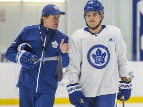 Maple Leafs coach Mike Babcock (left) talks with forward William Nylander during practice. Nylander has just three points in 14 games since returning from a contract holdout.
