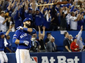 Jose Bautista of the Toronto Blue Jays hits a three-run homer against the Texas Rangers in Game 5 of the American League Division Series in Toronto on Wednesday, October 14, 2015. (STAN BEHAL /Toronto Sun)