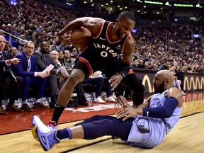 Toronto Raptors forward CJ Miles (0) wins the foul as Memphis Grizzlies forward Jaren Jackson Jr. (13) looks on from the floor during first half NBA basketball action in Toronto on Saturday, Jan. 19, 2019. THE CANADIAN PRESS/Frank Gunn ORG XMIT: FNG508