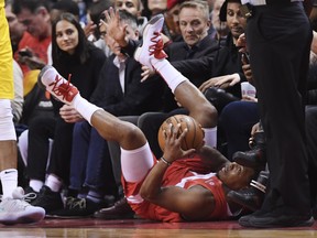 Toronto Raptors guard Kyle Lowry (7) falls out of bounds with the ball against the Indiana Pacers during first half NBA basketball action in Toronto on Sunday, Jan. 6, 2019. THE CANADIAN PRESS/Nathan Denette ORG XMIT: NSD504