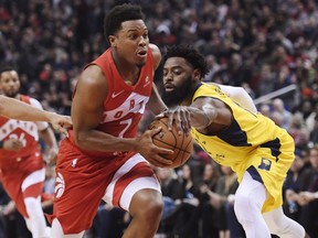 Toronto Raptors guard Kyle Lowry (7) drives past Indiana Pacers guard Tyreke Evans (12) during first half NBA basketball action in Toronto on Sunday, Jan. 6, 2019. THE CANADIAN PRESS/Nathan Denette
