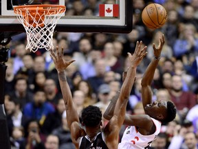 Raptors’ forward Chris Boucher (right) is fouled by Sacramento Kings forward Harry Giles during the second half on Tuesday night in Toronto. (FRANK GUNN/THE CANADIAN PRESS)