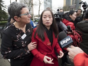 Former Burnaby South candidate Karen Wang is asked to leave the site where she had called a news conference for by Burnaby Public Library Chief Librarian Beth Davies in Burnaby, B.C. Thursday, Jan. 17, 2019. (THE CANADIAN PRESS/Jonathan Hayward)