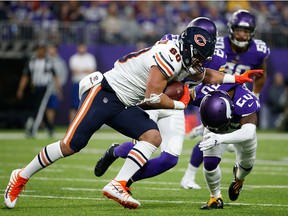 Chicago Bears tight end Trey Burton is tackled by Minnesota Vikings cornerback Mackensie Alexander after making a reception during the first half of an NFL football game, Sunday, Dec. 30, 2018, in Minneapolis.