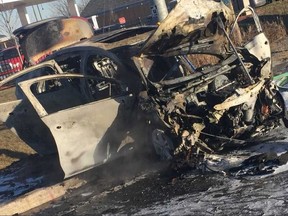 An alleged getaway driver was pulled out of a car before it burst into flames after a bank robbery, according the Halton Regional Police.