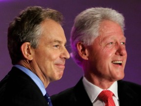 Then British prime minister Tony Blair (L) stands next to former U.S. president Bill Clinton after the latter's speech at the annual Labour Party conference at the GMEX Centre in Manchester, north-west England, 27 September 2006.(Carl de Souza/AFP/Getty Images)