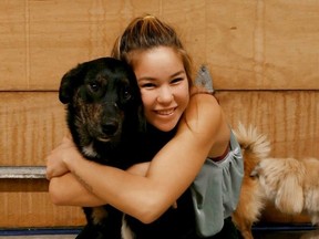 Alma Cadwalader, 19, of Oakland, is shown with Otto, 6, a labrador mix and one of her two dogs. Cadwalader was arrested on felony charges in an alleged "dog attackï"case. CADWALADER FAMILY