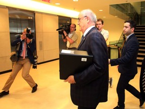 Veterans Affairs Minister Julian Fantino walks away from an angry milirary wife (not shown) after a Commons veterans committee in Ottawa, on May 29, 2014. (THE CANADIAN PRESS/Fred Chartrand)