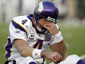 In this Oct. 31, 2010, file photo, Minnesota Vikings quarterback Brett Favre rubs his eyes after being hit by New England Patriots linebacker Gary Guyton during the first quarter of an NFL football game in Foxborough, Mass.  Favre says he might have had "thousands" of concussions during his Hall of Fame career.  (AP Photo/Winslow Townson, File)