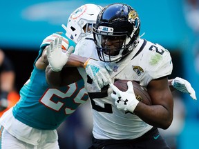 Leonard Fournette of the Jacksonville Jaguars tries to avoid the tackle of Minkah Fitzpatrick of the Miami Dolphins at Hard Rock Stadium on December 23, 2018 in Miami. (Michael Reaves/Getty Images)