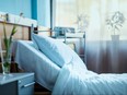 side view of empty hospital bed in clinic chamber