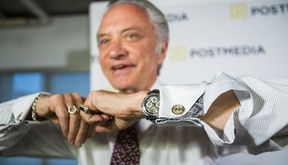 Postmedia President and CEO Paul Godfrey poses with “SUN” cufflinks after a press conference on Wednesday, March 25, 2015. (Ernest Doroszuk/Toronto Sun)