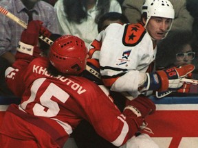 Andrei Khomutov of the Soviet National Team takes out Wayne Gretzky of the NHL All-Stars during an exhibition game on Feb. 13, 1987 in Quebec City.  Rendez-vous ’87, another NHL-versus-Soviet series, replaced the usual all-star contest. The teams split two games. Gretzky was named tournament MVP.