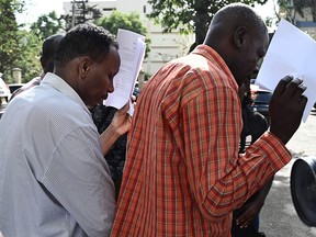 Oliver Muthee (right) and Guleid Abdihakim, two of the five suspects arraigned in court in connection with an Islamist attack on a Nairobi hotel complex leave the courthouse, on January 18, 2019 in Nairobi. (SIMON MAINA/AFP/Getty Images)