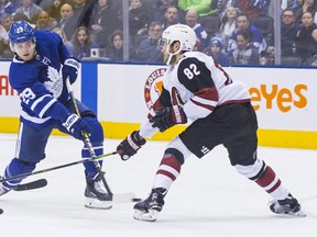 Toronto Maple Leafs' William Nylander (left) gets a shot away past Arizona Coyotes' Jordan Oesterle during first period NHL hockey action in Toronto, on Sunday, January 20, 2019.THE CANADIAN PRESS/Chris Young