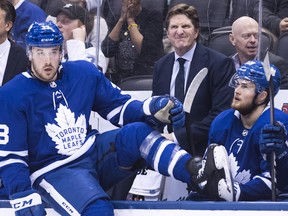 Toronto Maple Leafs head coach Mike Babcock, back centre, along with players Frederik Gauthier and William Nylander, right, look on against the Nashville Predators during third period NHL hockey action in Toronto on Monday, January 7, 2019.