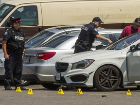 Toronto Police and SIU at the scene of a police involved shooting at a commercial plaza near Warden Ave. and Hymus Rd., north of St. Clair Ave., in Toronto, Ont. on Thursday June 7, 2018. The car is marked with what are believed to be bullet holes. (Ernest Doroszuk/Toronto Sun/Postmedia )