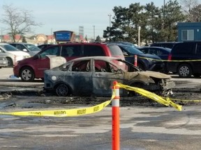 A burned-out car is seen in the parking lot of Woodbine Racetrack after a suspected arson, Friday, Jan. 11, 2019.