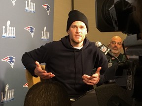 New England Patriots quarterback Tom Brady smiles while answering a question during the NFL football team's media availability for Super Bowl 53 in Atlanta on Wednesday, Jan. 30, 2019. (John Kyrk/Postmedia Network)