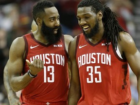 Rockets’ James Harden (left) and Kenneth Faried share a laugh during their team’s win on Friday night in Houston. Harden finished with 35 points, his second-fewest this month. (AP PHOTO)