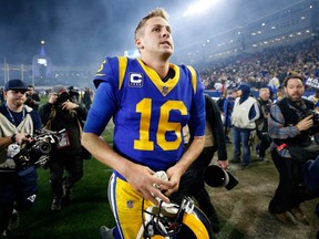 Rams quarterback Jared Goff runs off the field after defeating the Cowboys in the NFC Divisional Playoff game at Los Angeles Memorial Coliseum on Jan. 12, 2019.