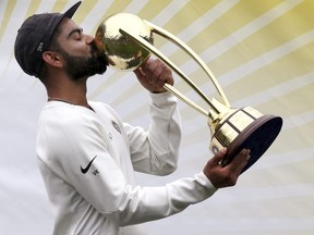 India's Virat Kohli kisses the Border-Gavaskar Trophy as he celebrates their series win over Australia after play was called off on day 5 of their cricket test match in Sydney, Monday, Jan. 7, 2019. The match is a draw and India wins the series 2-1.(RICK RYCROFT/AP)
