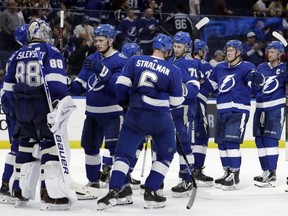 Lightning goaltender Andrei Vasilevskiy (88) celebrates with teammates after a 4-0 win over the Blue Jackets during an NHL game in Tampa, Fla., Tuesday, Jan. 8, 2019.