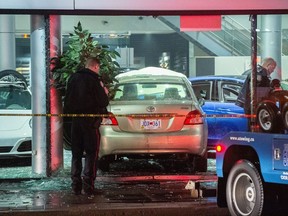 Toronto Police at the scene after a Toyota Yaris was driven into the showroom of a Porsche dealer on Front Street at Parliament Street on Monday, Jan. 7, 2019. (Victor Biro photo)