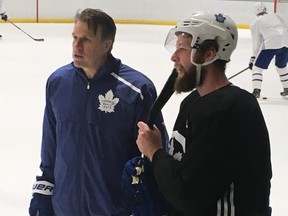 From left: Leafs assistant coach Jim Hiller and newly acquired defenceman Jake Muzzin at practice in Detroit on Thursday. TERRY KOSHAN/TORONTO SUN