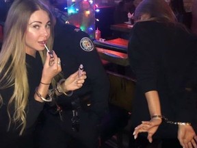 A still from a series of videos posted to social media depicting Toronto Police officers Sunday evening pretending to handcuff bar patrons.