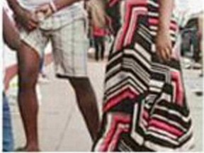 OUCH! An irate Nigerian wife drags her husband through the street by his penis after catching him cheating.