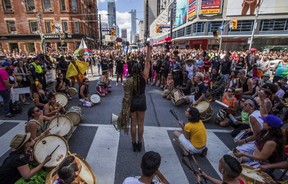 People from the Black Lives Matter sit on the ground to halt the annual Pride Parade, in Toronto on Sunday, July 3, 2016. (THE CANADIAN PRESS/Mark Blinch)