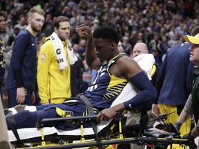 Indiana Pacers guard Victor Oladipo is taken off the court on a stretcher after he was injured during the first half of the team's NBA basketball game against the Toronto Raptors in Indianapolis, Wednesday, Jan. 23, 2019. (AP Photo/Michael Conroy) ORG XMIT: NAF107