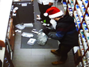 Robert Collings wears a Santa hat as he robs a pharmacy in York Region.